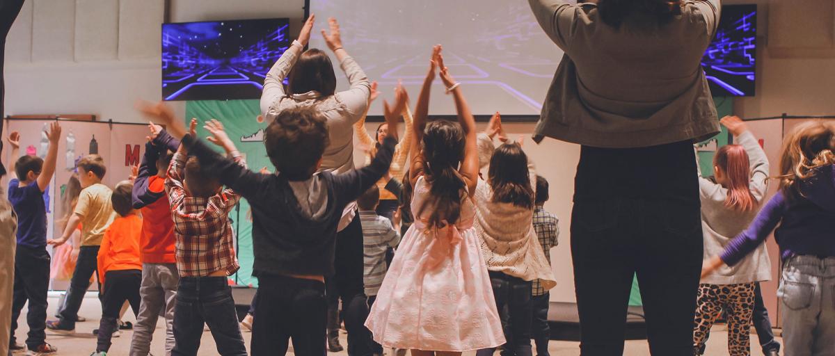 Children lifting hands in worship